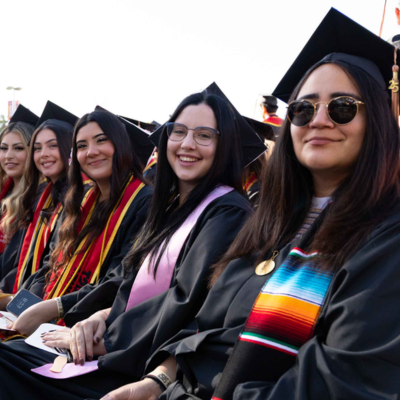 Five graduates at a Commencement ceremony at Stan State