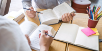 Two people reading a book