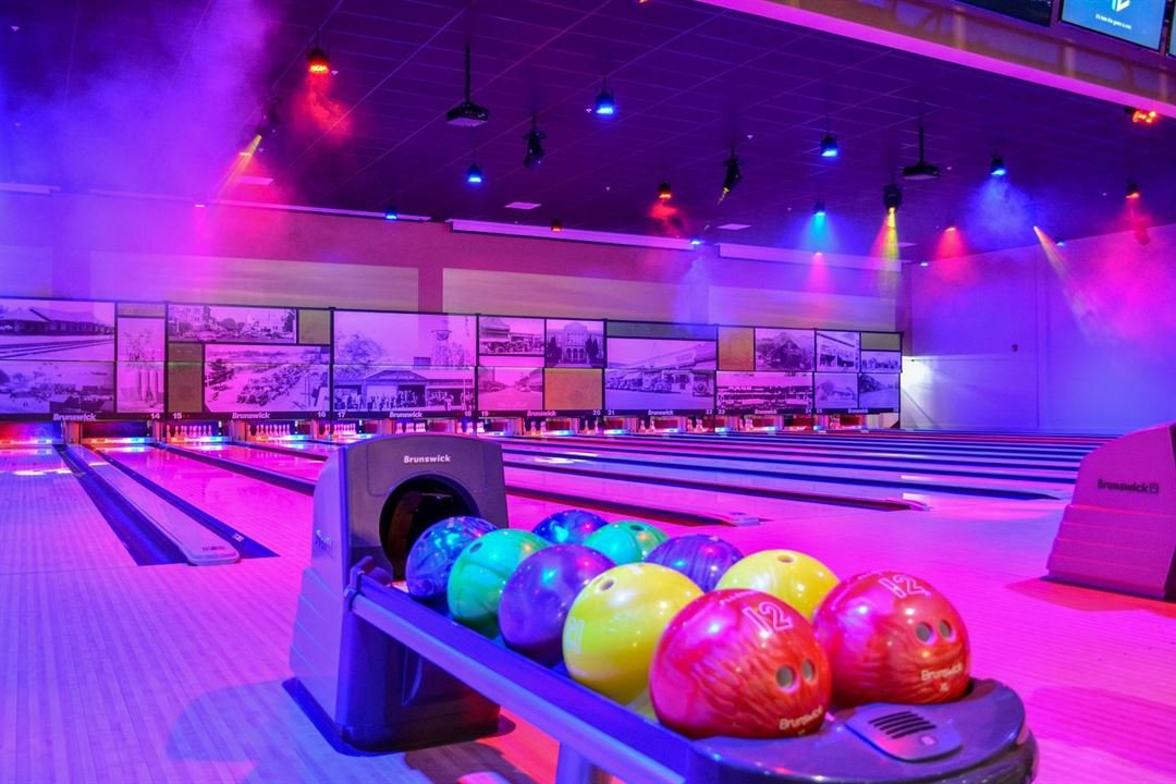 Bowling balls set up in front of bowling lanes