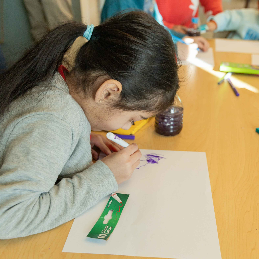 Child participating in a Stan State art event.