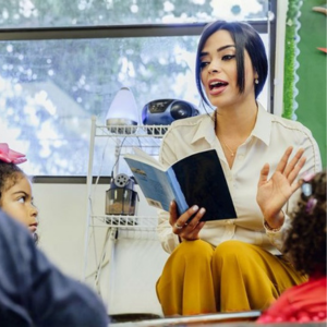 A female educator reads to a group of small children