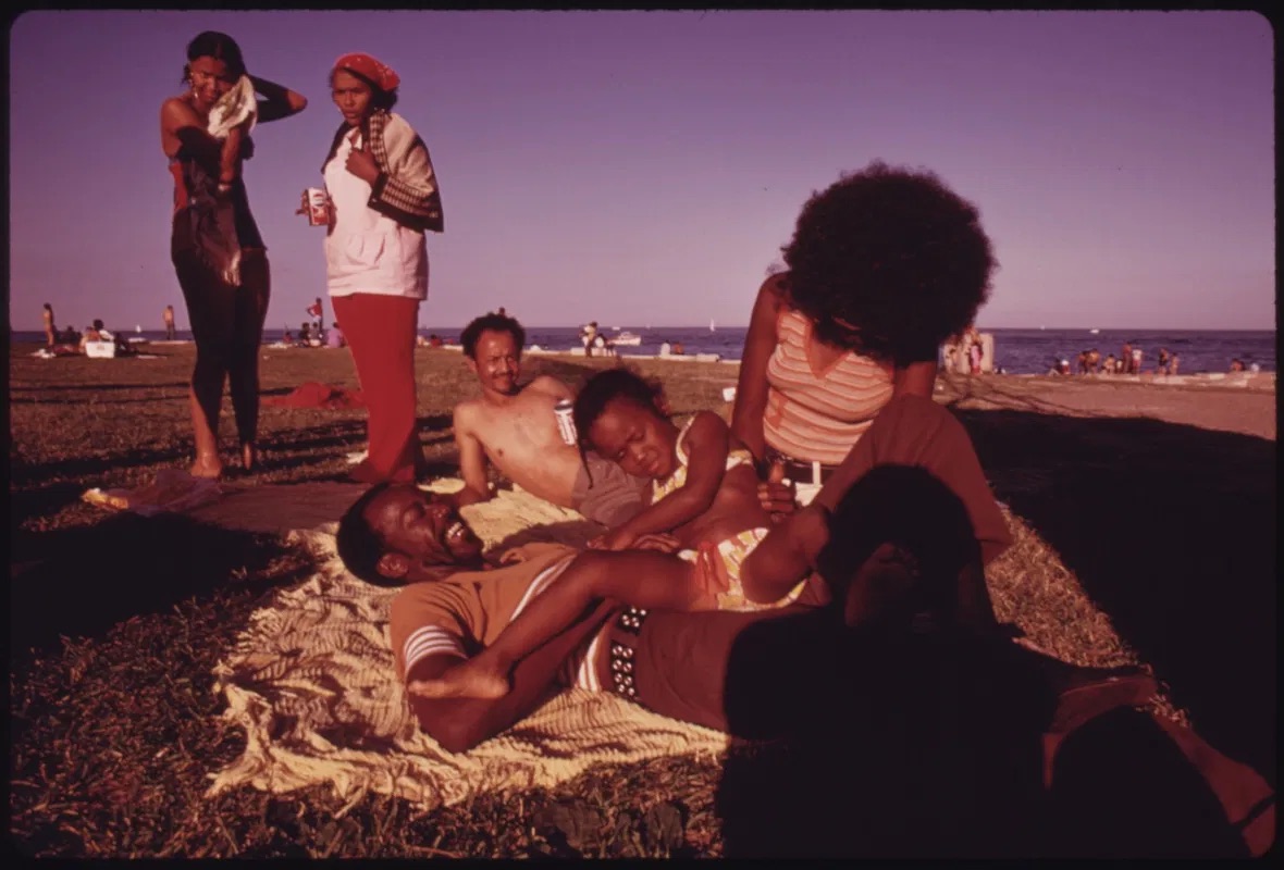 African American family enjoying summer weather at a beach in Chicago.
