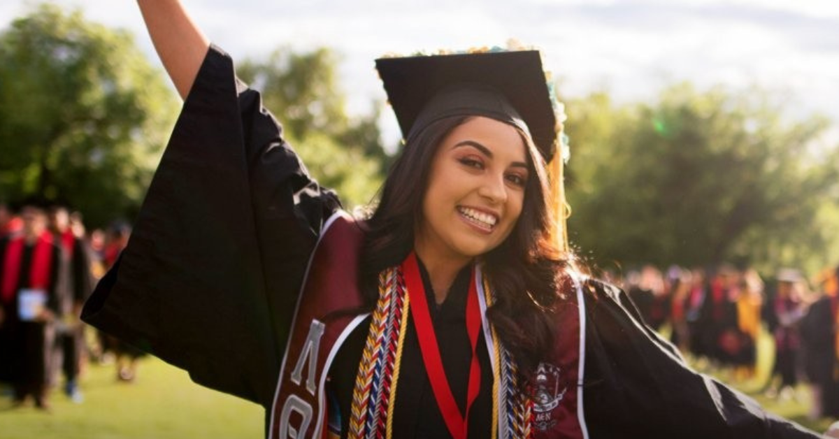 A proud female graduate poses for a photo