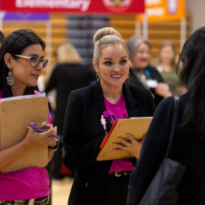 Three women talking at a career fair