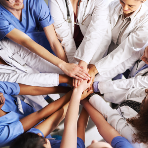 Healthcare professionals huddling together