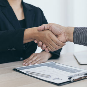Two people shaking hands at an interview