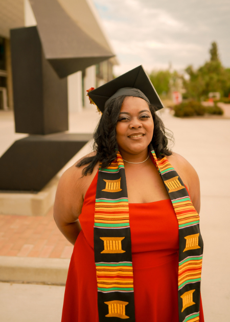 Delilah Rice poses in her cap and gown after receiving her undergraduate degee.