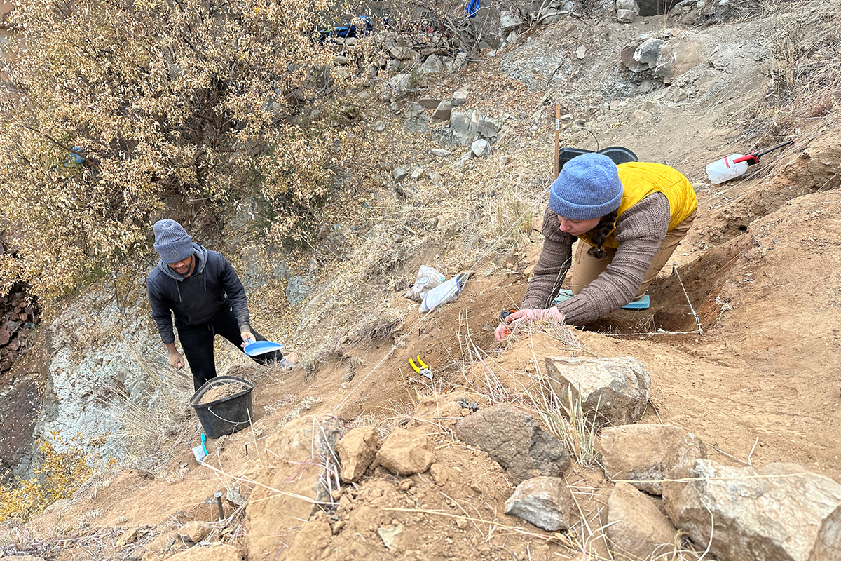 Researchers Lefa Leanya of Stellenbosch University, South Africa, and Kyra Pazan of California State University, Stanislaus, excavate Likonong Rock Shelter in the mountains of Lesotho. 