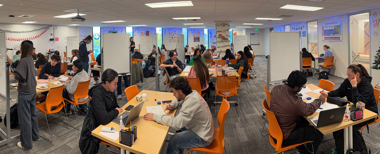 Many students are seen inside a busy Learning Commons tutoring center