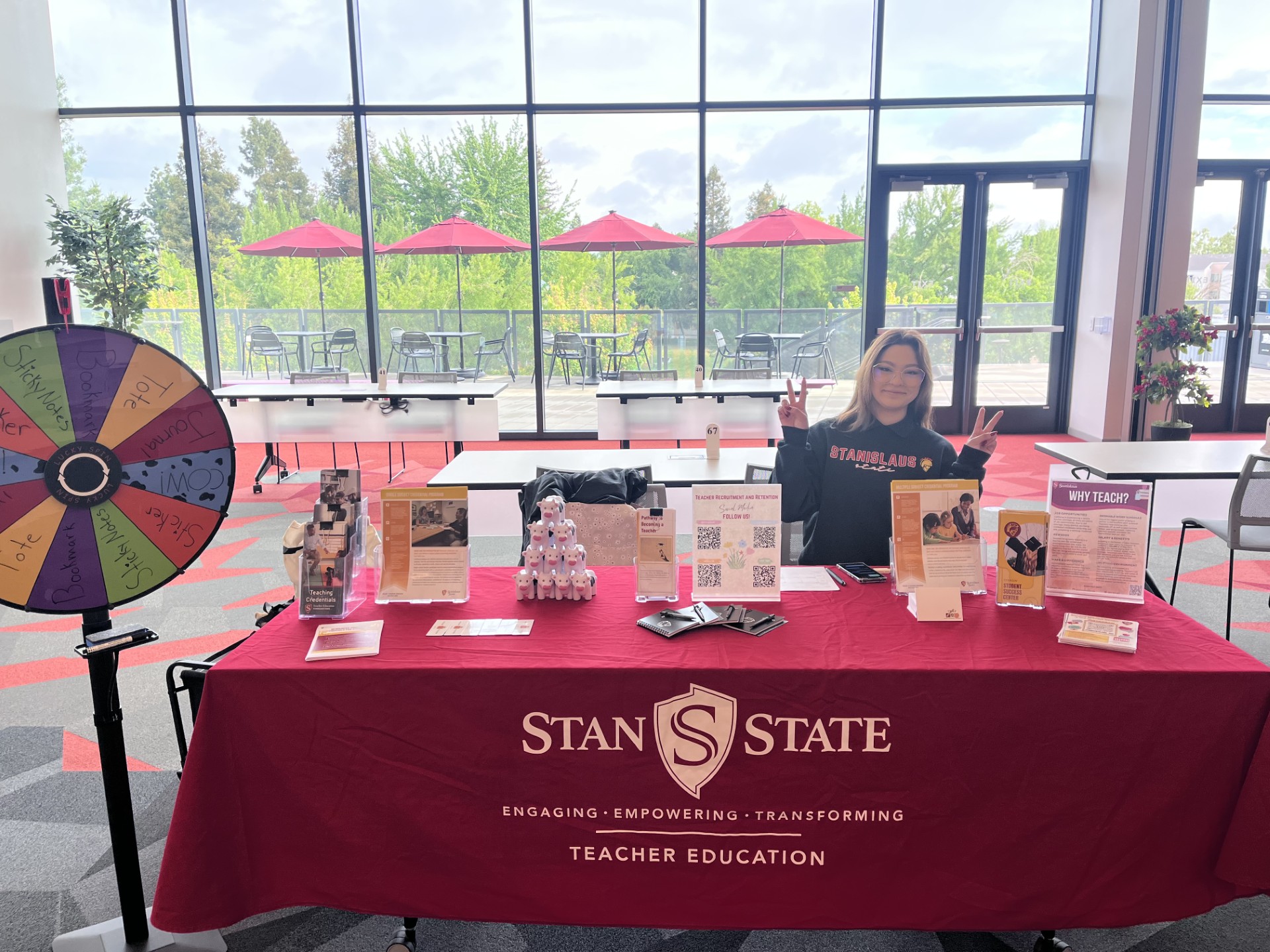 Student Ambassador and swag items on table while tabling at Warrior Welcome.