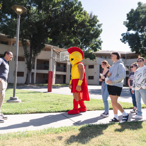 Titus is seen with students walking on the Housing Village tour at Stan State