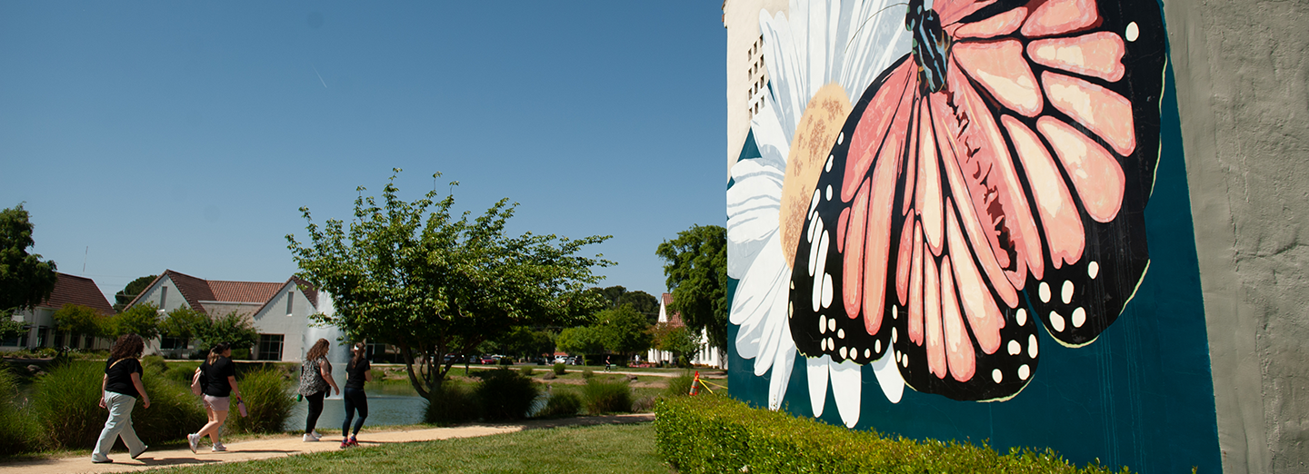 Students at Stockton Campus. Butterfly mural. 
