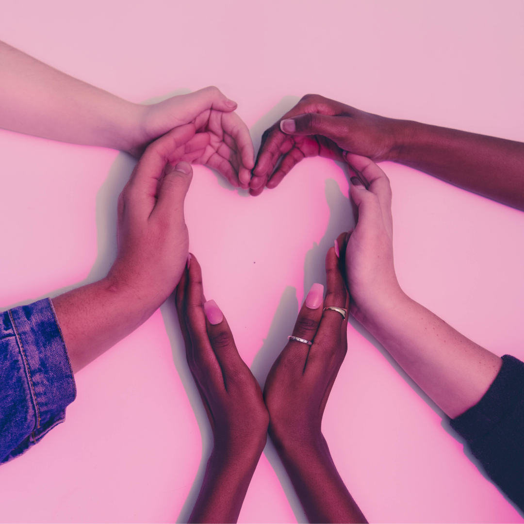 People coming together and forming a heart with their hands.