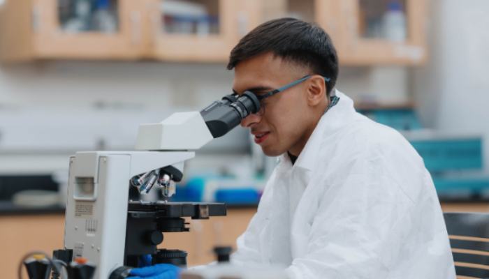 Student using a microscope in a science lab