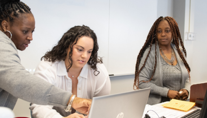 People reviewing information together on a laptop