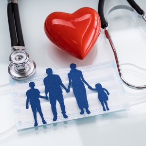 A stethoscope, heart, mask, and a paper cutout of a family
