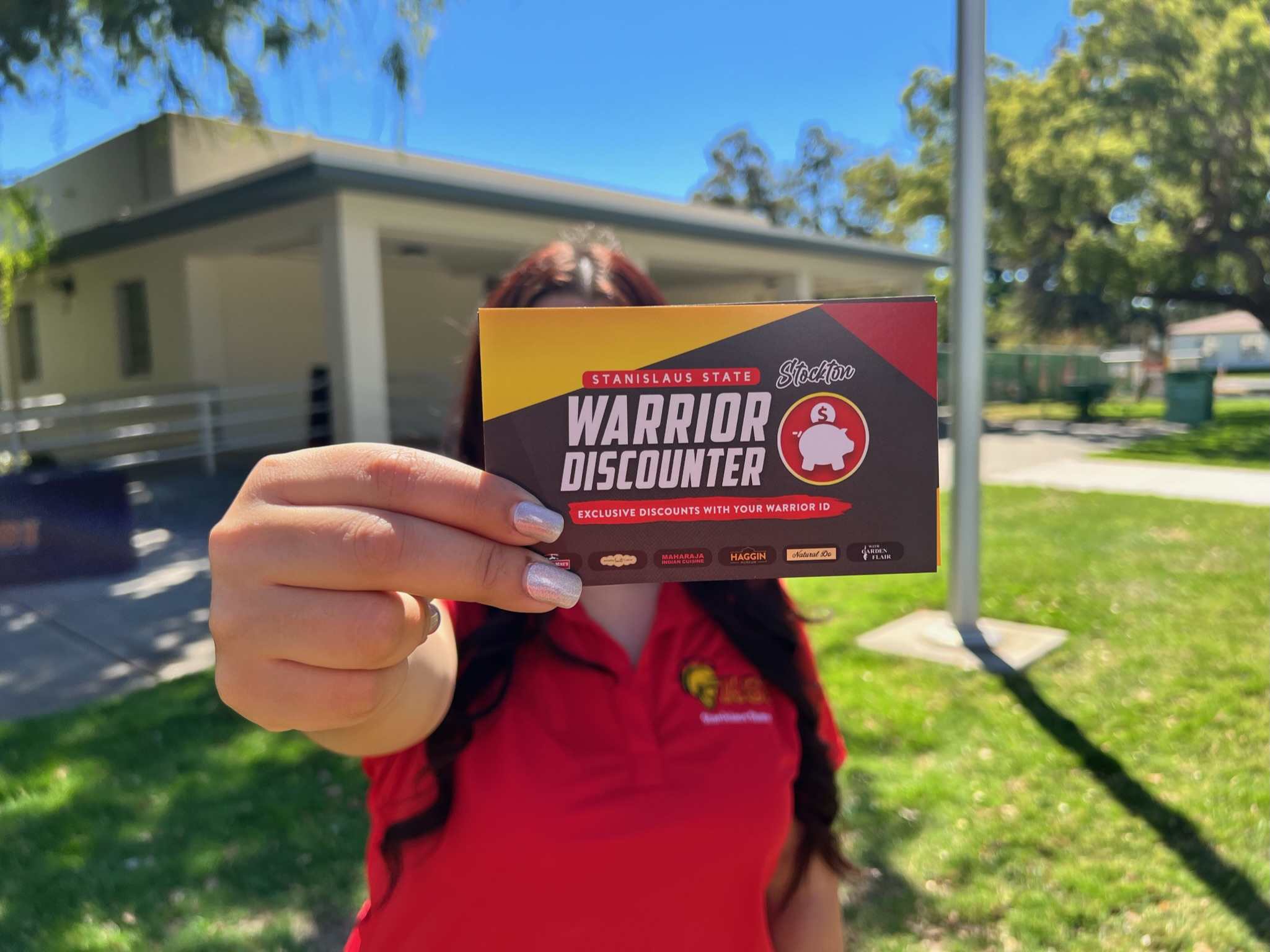 Student Holding up Warrior Discounter Info Card