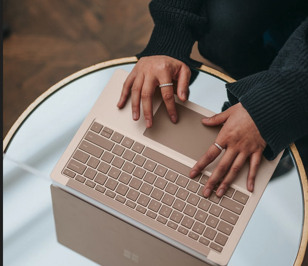 a user is seen on a laptop