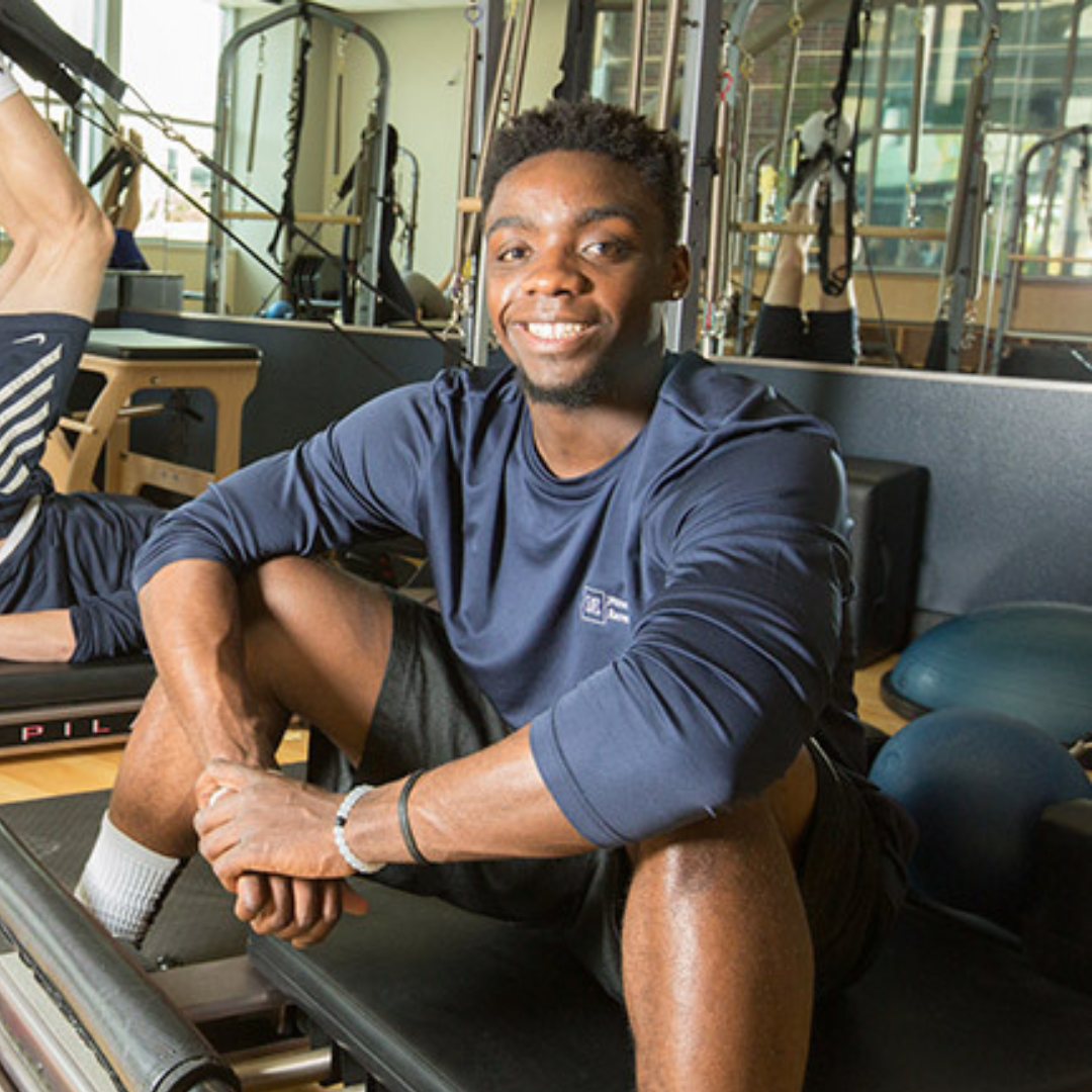 Student posing for photo at the gym.
