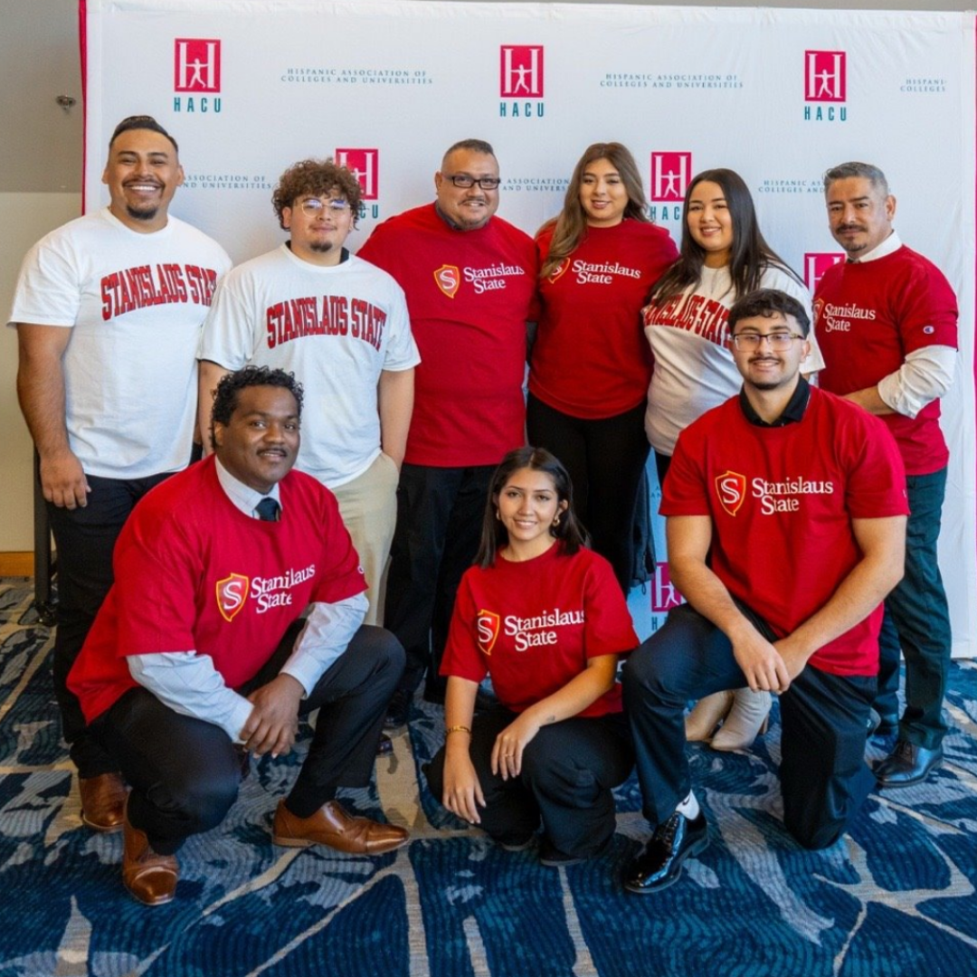 Group of staff and students posed for a photo at a conference.