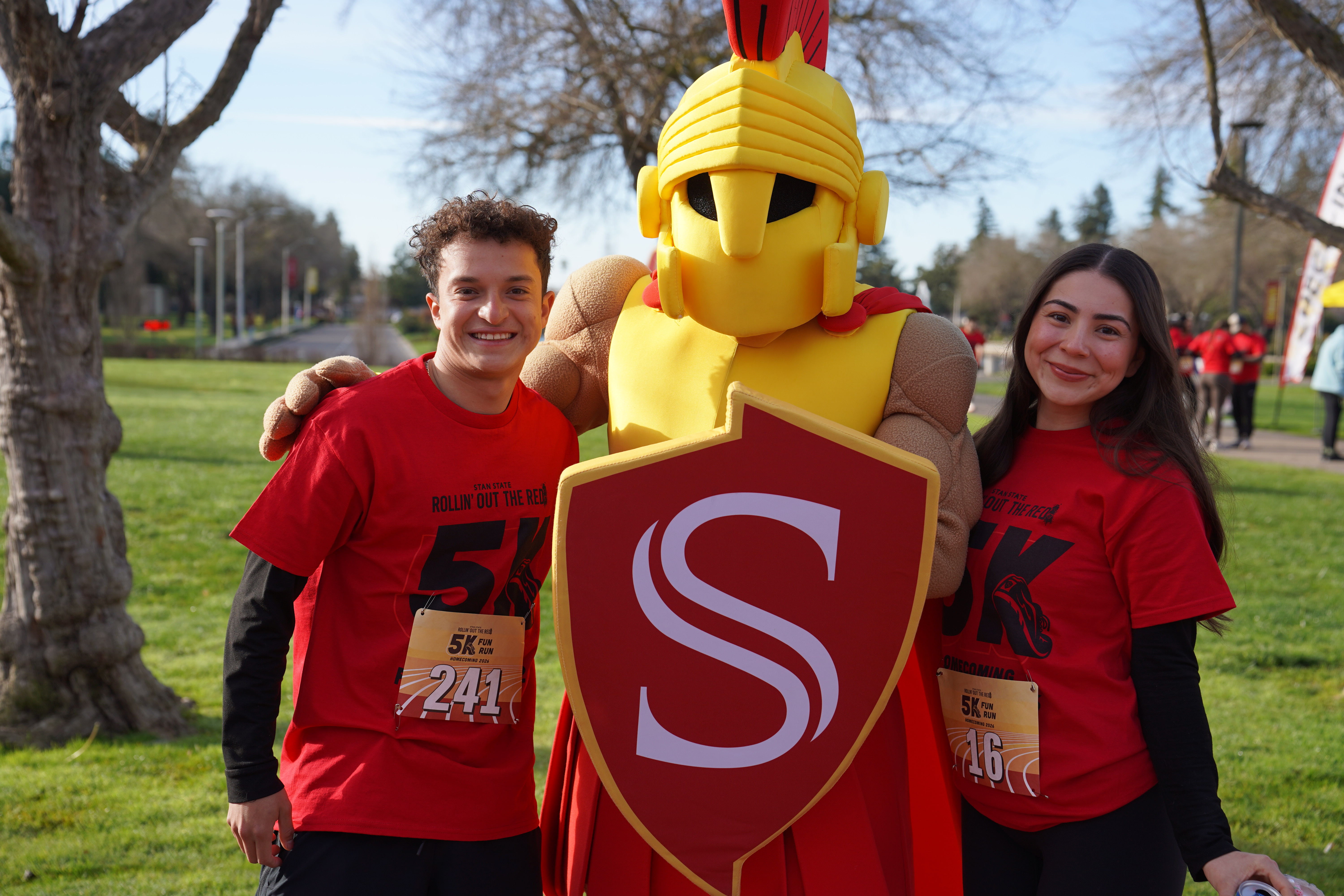 Two student 5k Fun Run participants standing next to Titus