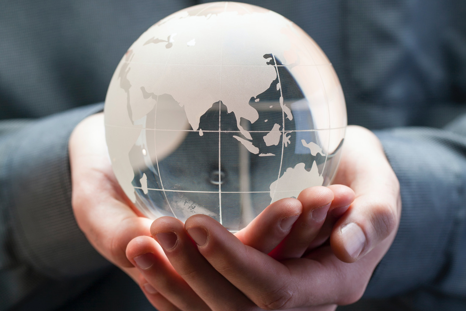 glass earth in person's hand