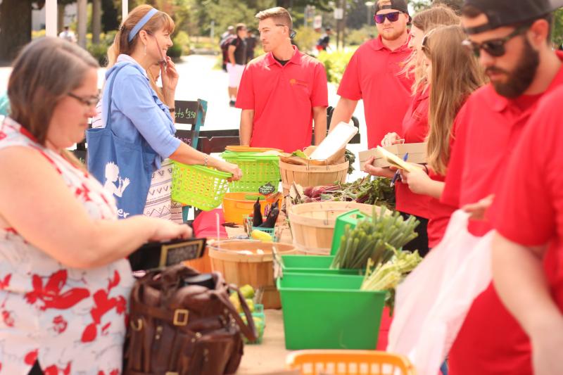 Students selling fresh veggies