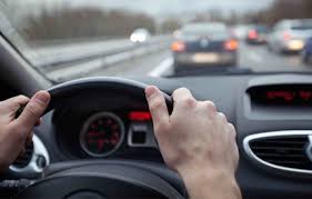 Hands on steering wheel driving in traffic