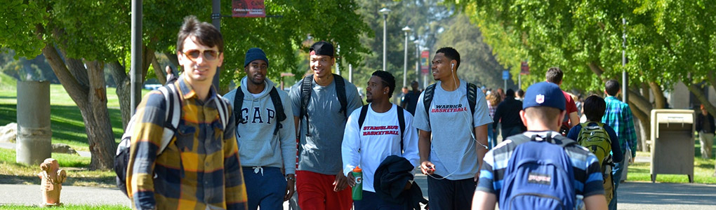 Students walking along walkway by the quad