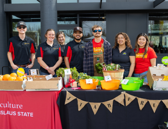 Students at the StanFresh Market event pose for a group photo at their produce stand.