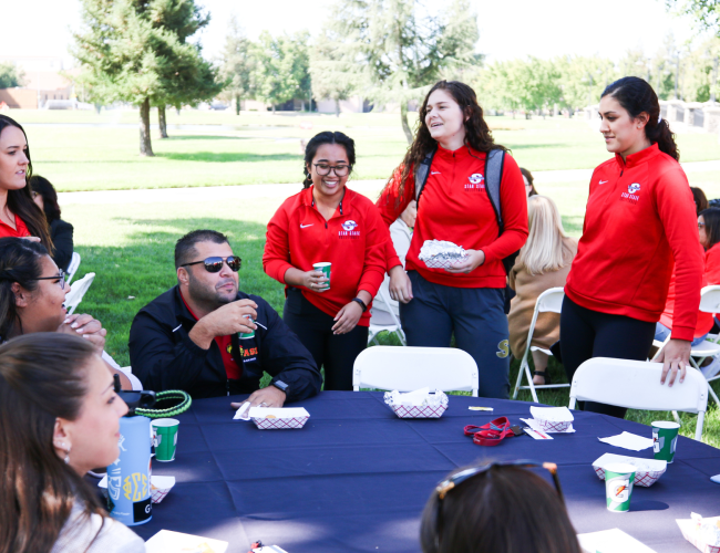 Various students gathered at a table.