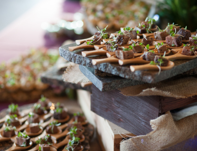 A table displaying an assortment of small trays filled with various types of food.