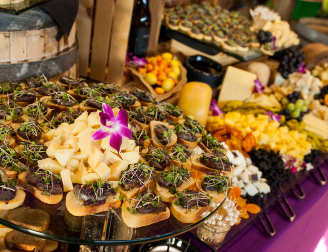A buffet table featuring numerous food selections, from entrees to sweet treats.