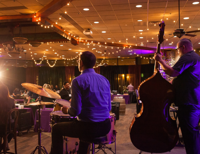 A band playing for a room full of people.