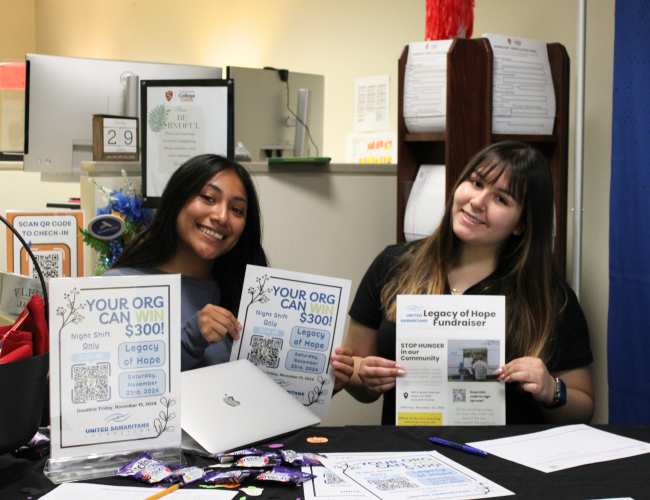 2 Fellows tabling in the College Corps office for the annual Legacy of Hope event