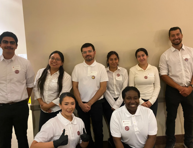 Group of fellows in white polos volunteering at the Legacy of Hope evening shift