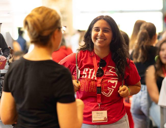 A student is seen talking to university staff at NSO