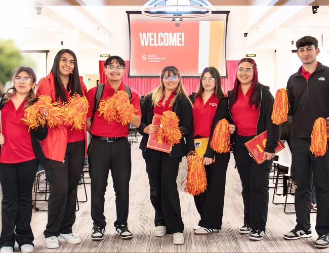 Group of Orientation Leaders waving to the camera
