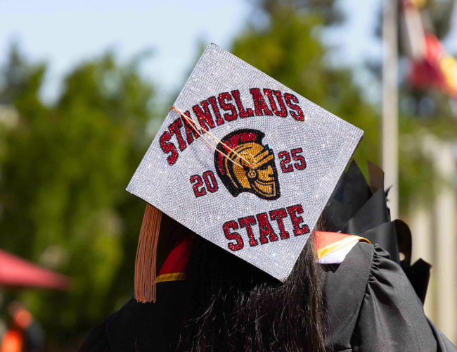 A graduate cap, that decoratively reads: "Stanislaus State 2025"