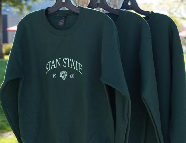 A green Stan State crew neck sweater