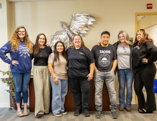 Warrior re-engagement staff group photo with eagle sculpture