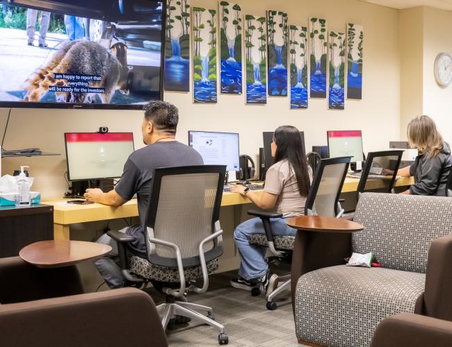 Students working at computers in re-engagement center