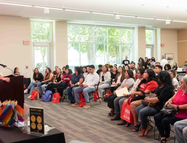 Dr. Stuart Wooley delivers a speech to students in the MSR 100 conference room at Stan State