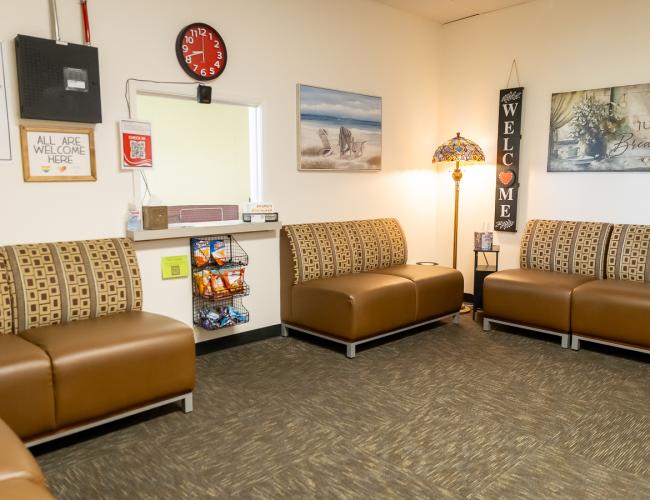 Counseling waiting room with brown sofas and welcome decor