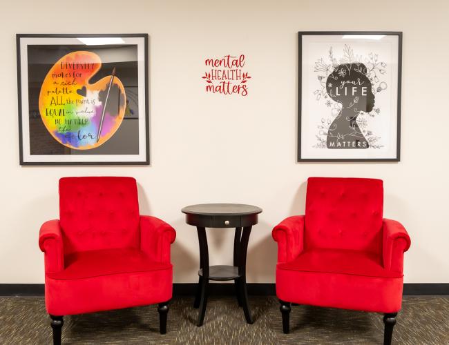 Red chairs with mental health matters wall art