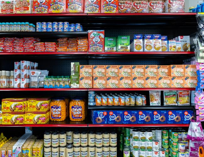Food pantry shelves stocked with groceries and snacks