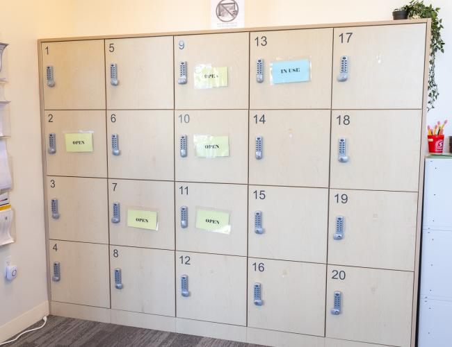 Numbered testing lockers with open and in-use labels