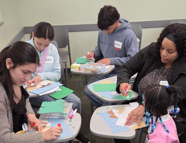 MSTI students are seen working on an arts and crafts project with school children.