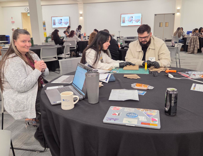 Three students at a table participating in an MSTI activity.