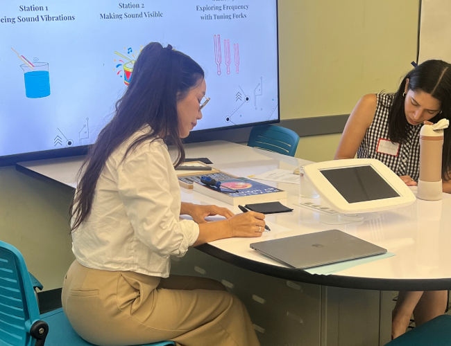Two MSTI students sitting at a desk studying.